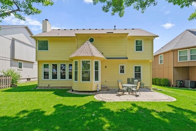12606 Slater St, Overland Park, KS 66213 - back of property featuring a patio and a chimney