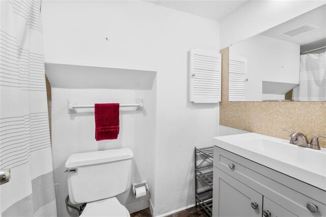8215 Santa Fe Dr Unit 10, Overland Park, KS 66204 - full bath with visible vents, decorative backsplash, toilet, and vanity