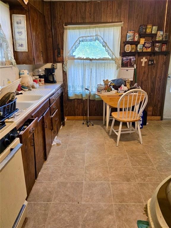3526 Belmont Ave, Parsons, KS 67357 - kitchen with wooden walls and dark brown cabinetry