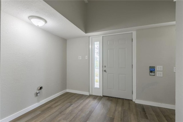 entryway with baseboards and wood finished floors