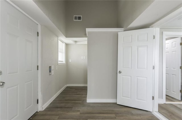 interior space with visible vents, baseboards, and dark wood-type flooring