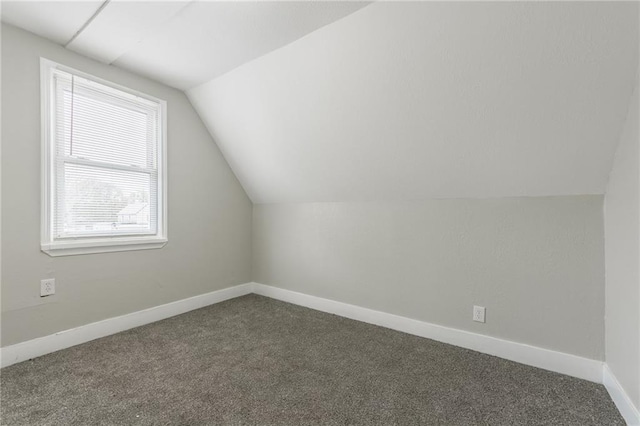 bonus room with vaulted ceiling, baseboards, and carpet flooring