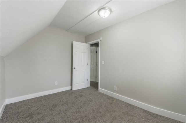 additional living space with baseboards, carpet flooring, and lofted ceiling