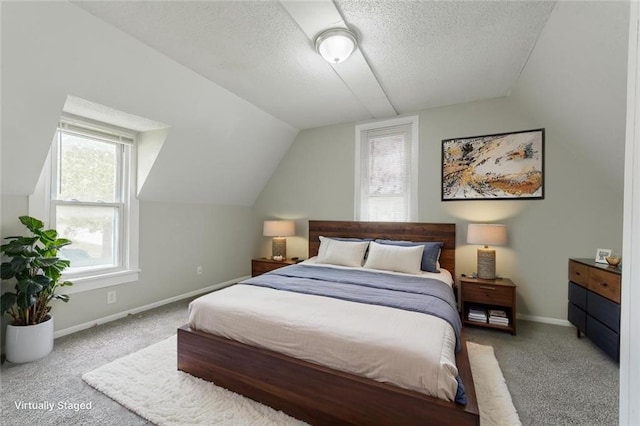 carpeted bedroom featuring baseboards, a textured ceiling, and lofted ceiling