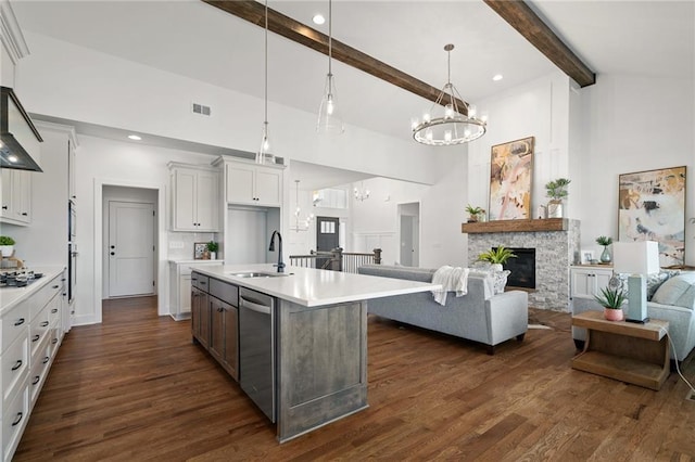 kitchen featuring light countertops, high vaulted ceiling, open floor plan, and a sink