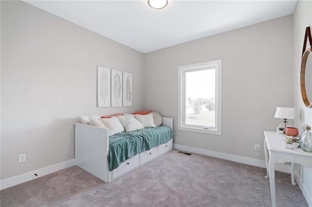 bedroom with baseboards, visible vents, and carpet