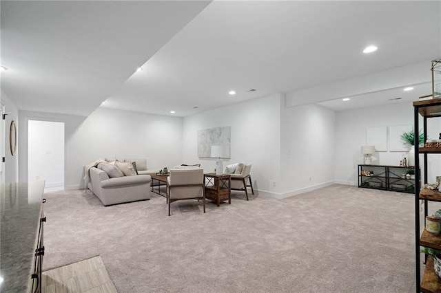 carpeted living area featuring recessed lighting and baseboards