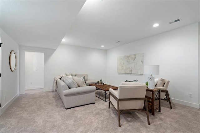carpeted living area featuring recessed lighting, baseboards, and visible vents
