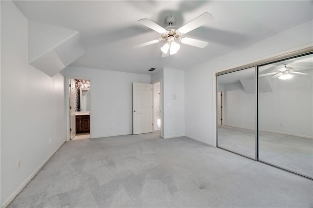 2269 SW Park Ave, Blue Springs, MO 64015 - unfurnished bedroom featuring carpet floors, a closet, ceiling fan, and ensuite bathroom