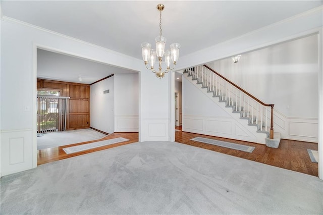 2269 SW Park Ave, Blue Springs, MO 64015 - unfurnished dining area featuring ornamental molding, a decorative wall, a chandelier, carpet, and stairway