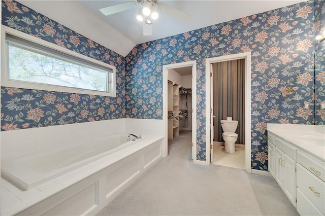 2269 SW Park Ave, Blue Springs, MO 64015 - full bath with a garden tub, a ceiling fan, vanity, wallpapered walls, and a walk in closet