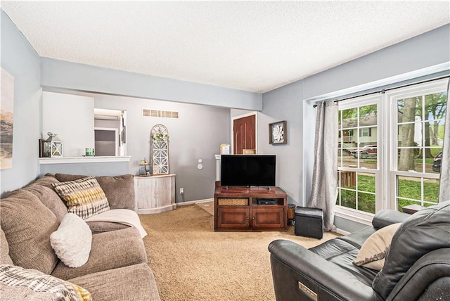 living room featuring a textured ceiling, visible vents, light carpet, and baseboards