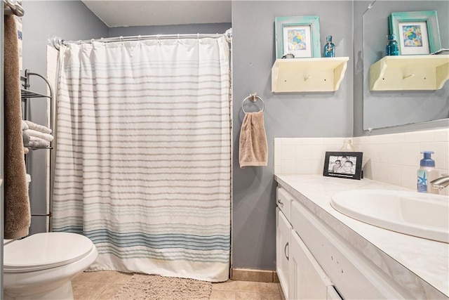 full bathroom featuring tasteful backsplash, vanity, tile patterned floors, toilet, and shower / bath combo with shower curtain