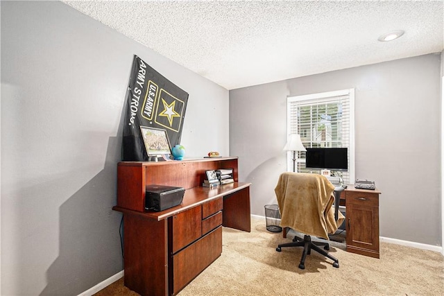 office space with baseboards, a textured ceiling, and light colored carpet
