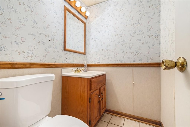 bathroom with tile patterned flooring, wainscoting, toilet, and vanity