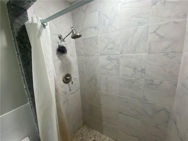 full bathroom with a tile shower