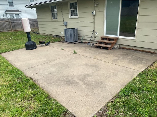 view of patio featuring central AC, fence, and entry steps