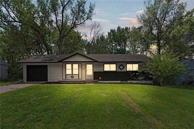 ranch-style house with an attached garage, a front lawn, and concrete driveway
