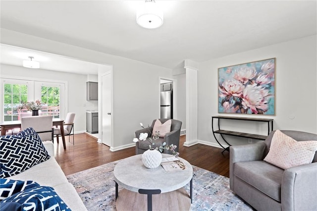 living room with baseboards and dark wood finished floors