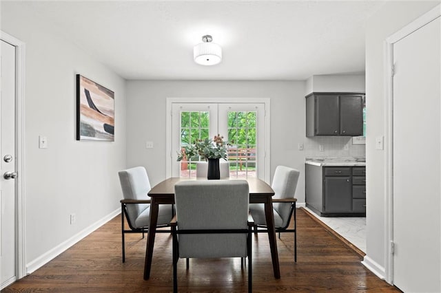 dining area with baseboards and dark wood-style flooring
