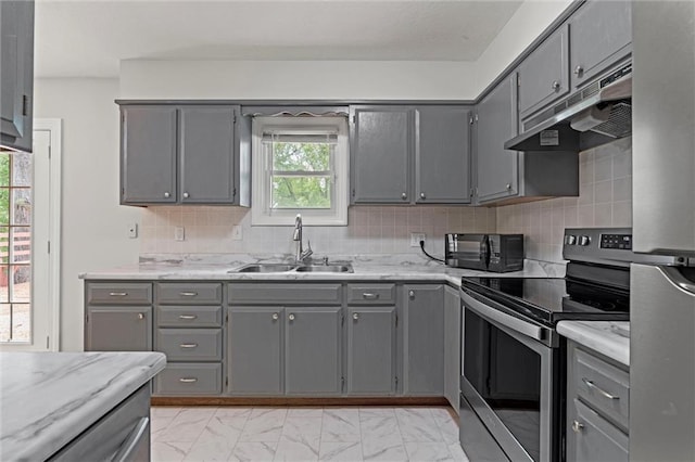 kitchen featuring under cabinet range hood, gray cabinets, and electric stove