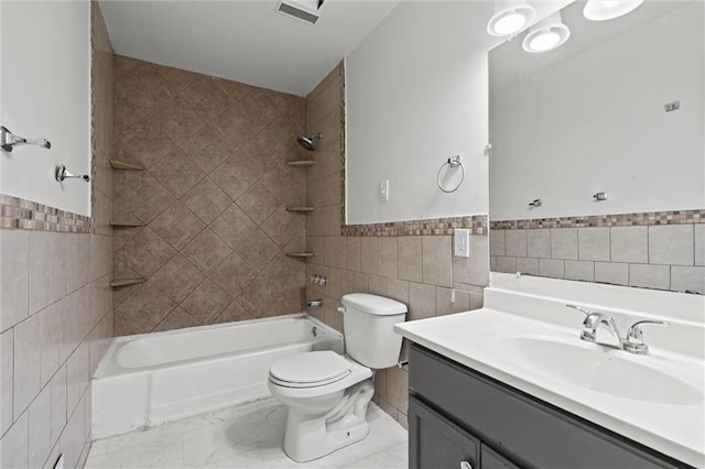 full bath with tile walls, shower / bathtub combination, a wainscoted wall, and toilet