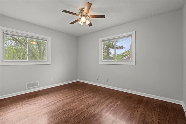 spare room with visible vents, baseboards, and a wealth of natural light