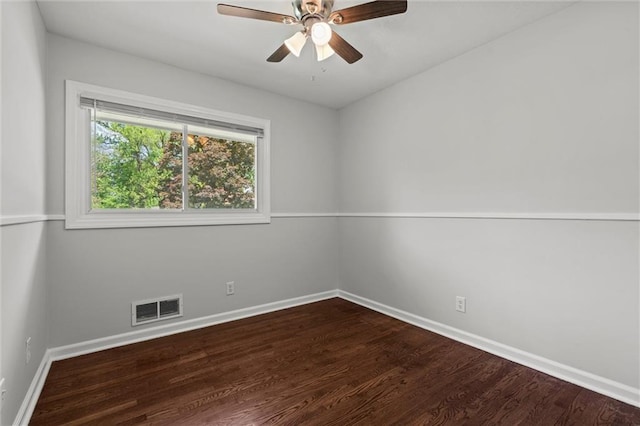 spare room with visible vents, a ceiling fan, baseboards, and wood finished floors