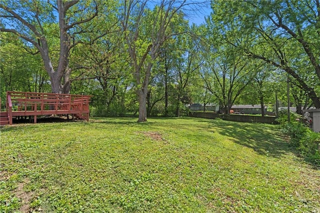 view of yard featuring fence and a deck
