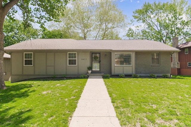 2427 N 83rd Ln, Kansas City, KS 66109 - view of front of property with a front yard and brick siding