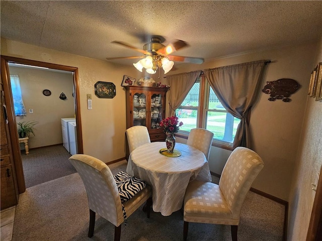 carpeted dining space with baseboards, a ceiling fan, a textured ceiling, and washer and clothes dryer