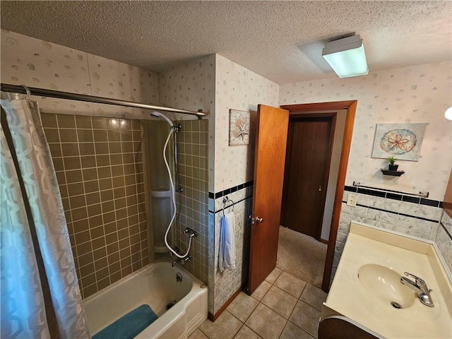 full bath with wallpapered walls, shower / bath combination with curtain, a textured ceiling, and tile patterned flooring