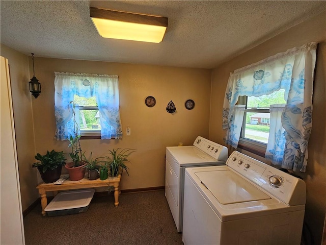laundry room with washer and dryer, a textured ceiling, laundry area, and plenty of natural light