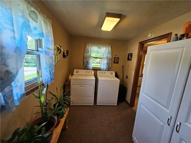 clothes washing area featuring dark carpet, a textured ceiling, independent washer and dryer, and laundry area