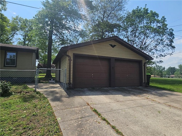 detached garage featuring fence