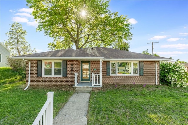 view of front of property with brick siding and a front yard