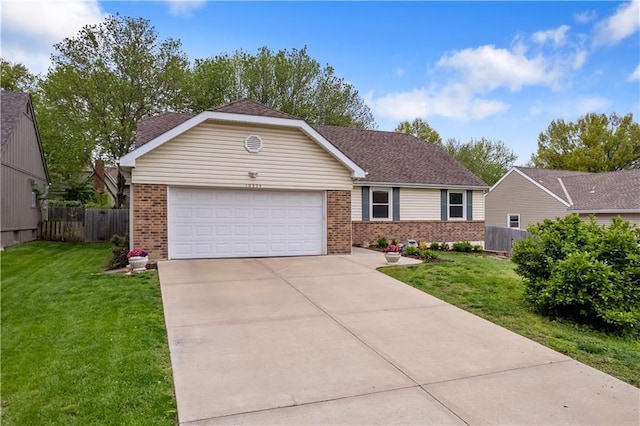 ranch-style home featuring a garage, concrete driveway, a front yard, and brick siding