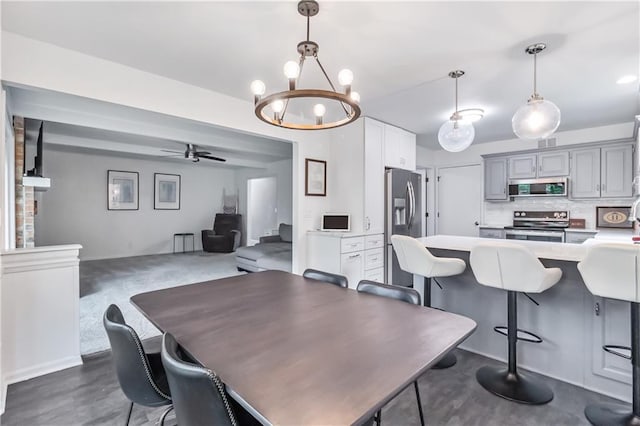 dining room featuring baseboards, ceiling fan with notable chandelier, and visible vents