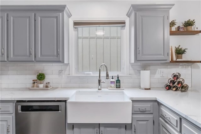 kitchen featuring decorative backsplash, gray cabinets, open shelves, dishwasher, and a sink