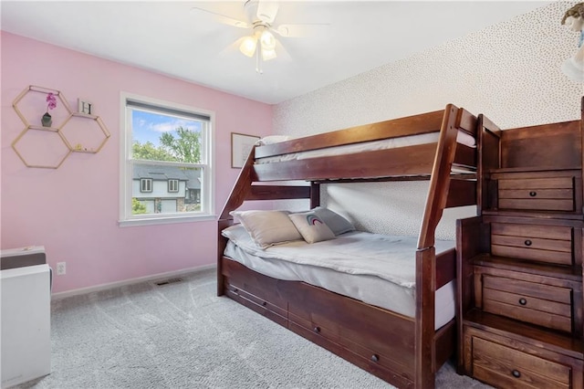 bedroom with baseboards, a ceiling fan, carpet flooring, and visible vents