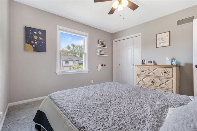 bedroom featuring a ceiling fan, visible vents, carpet floors, baseboards, and a closet