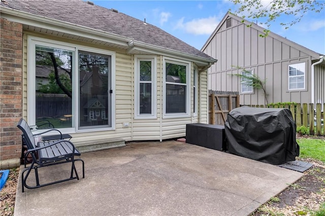 view of patio / terrace featuring fence and a grill