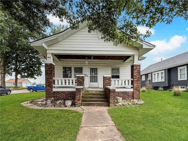 601 W 22nd St, Higginsville, MO 64037 - view of front of house with covered porch and a front yard