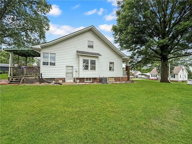 601 W 22nd St, Higginsville, MO 64037 - rear view of house with a yard and central AC unit