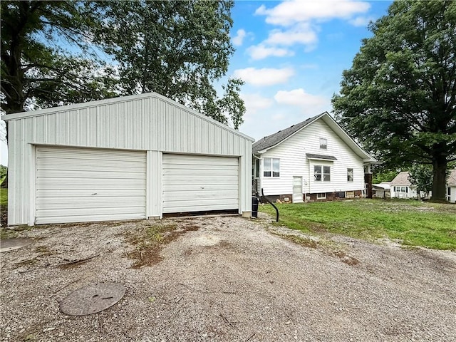 601 W 22nd St, Higginsville, MO 64037 - view of home's exterior featuring an outbuilding and a detached garage