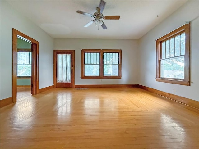 601 W 22nd St, Higginsville, MO 64037 - empty room featuring baseboards, light wood finished floors, and a ceiling fan