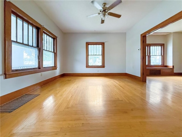 601 W 22nd St, Higginsville, MO 64037 - empty room with healthy amount of natural light, baseboards, and ceiling fan