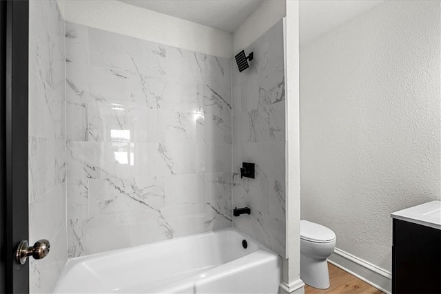 bathroom with vanity, toilet, bathtub / shower combination, baseboards, and wood finished floors