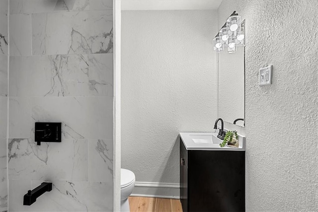 full bathroom featuring walk in shower, toilet, wood finished floors, and vanity