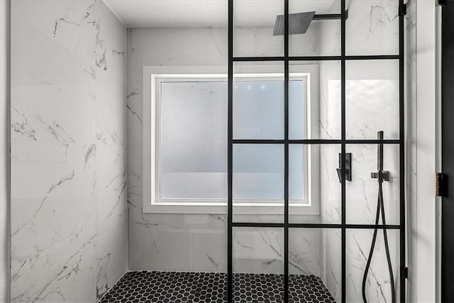 interior space with a marble finish shower